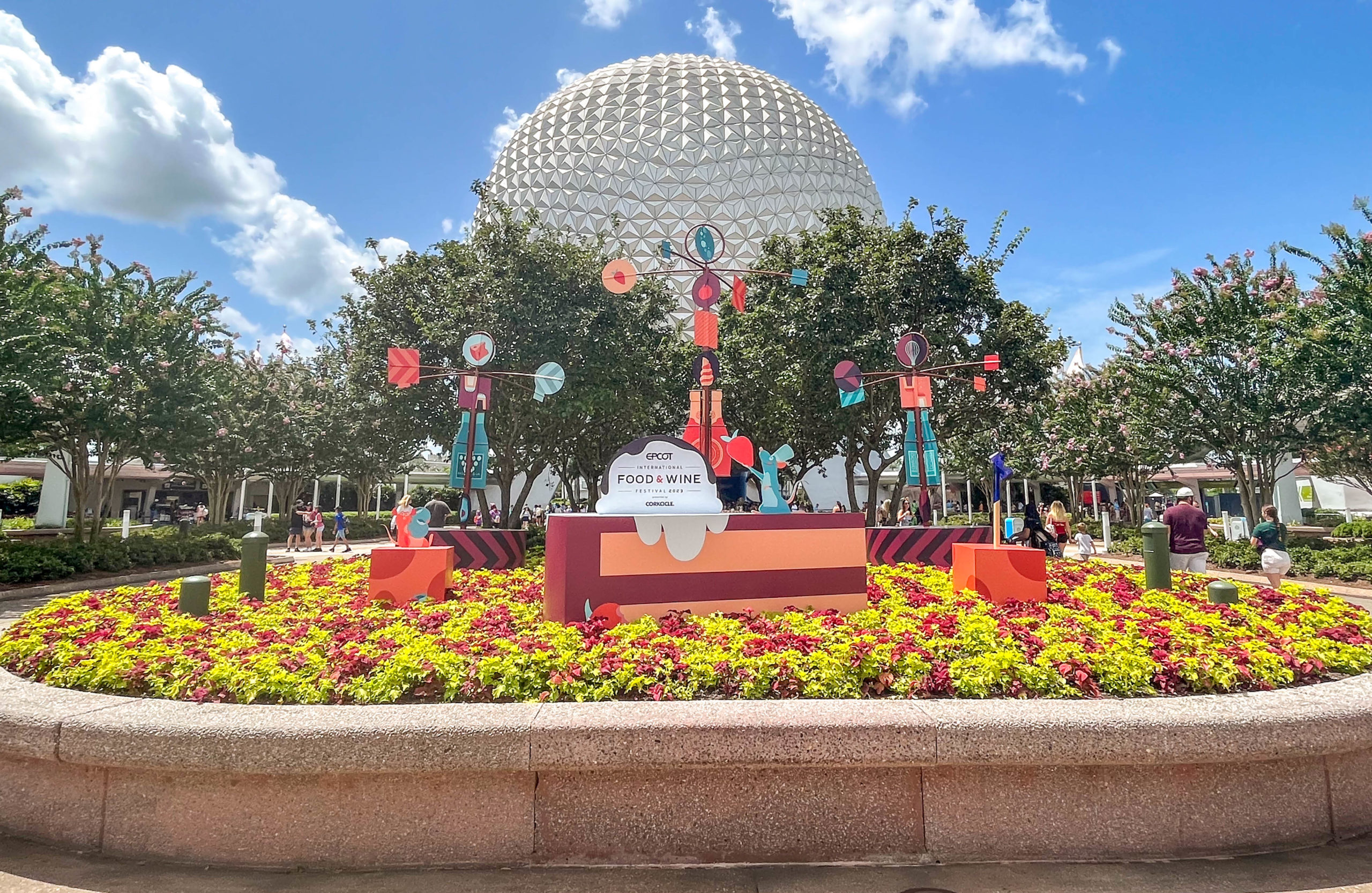 https://mickeyblog.com/wp-content/uploads/2023/07/2023-wdw-epcot-food-and-wine-festival-spaceship-earth-entrance-signs-decor-stock-2-scaled.jpg