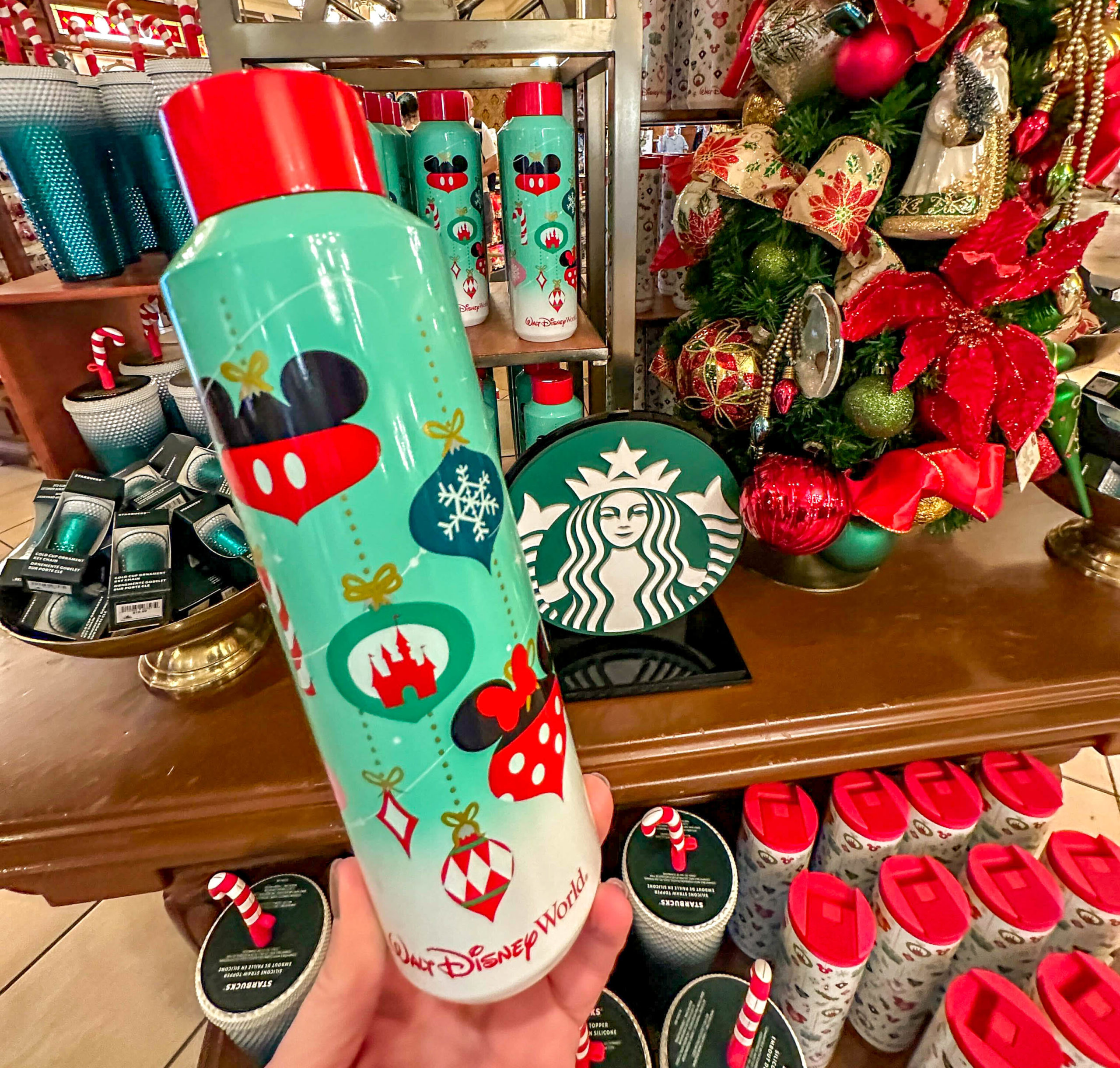 The 2023 holiday Disney x Starbucks tumbler topped off with a silicone  candy cane straw cover. It's like Disney knows that I absolutely do…