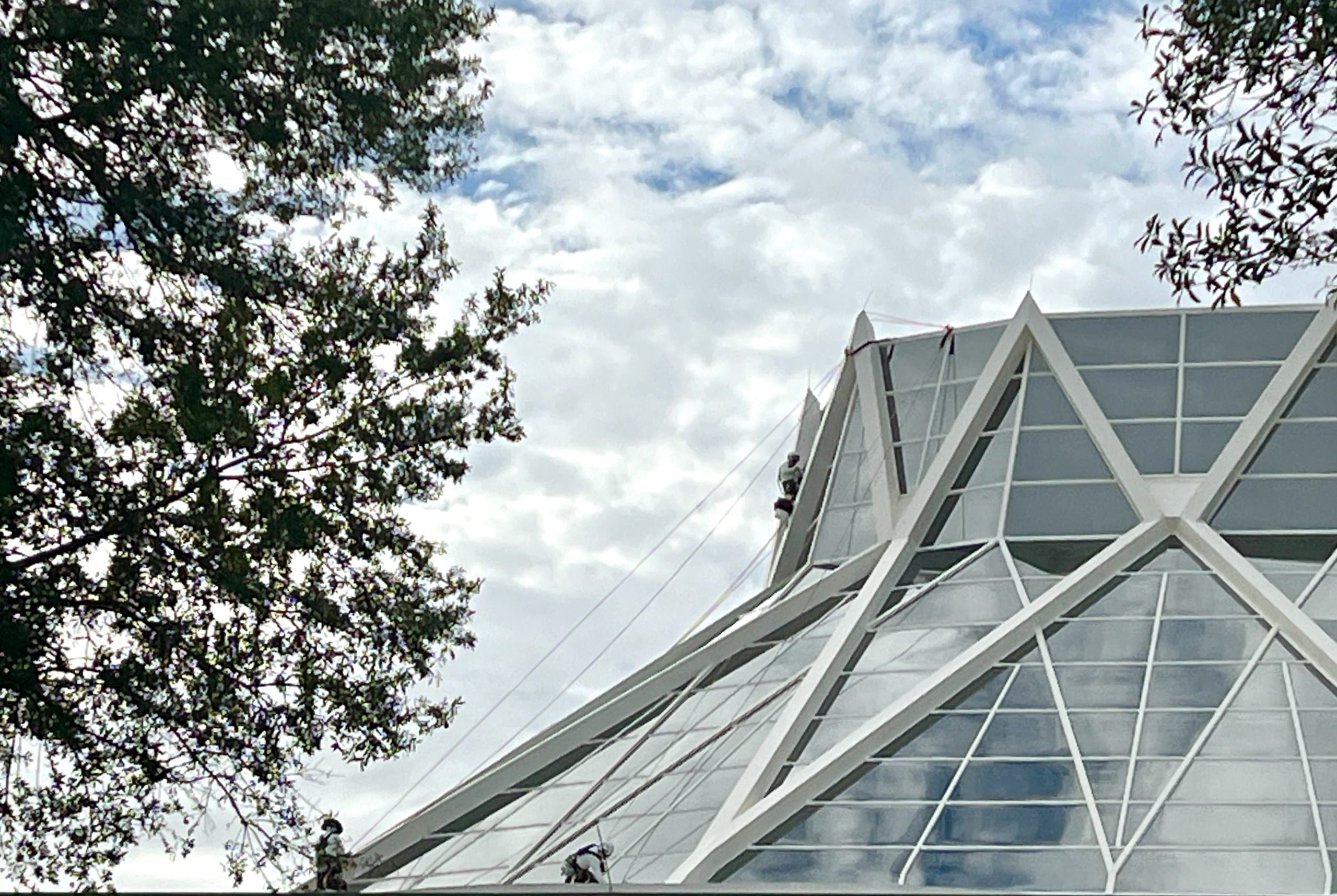Construction Workers Scale the Roof at The Land Pavilion in EPCOT